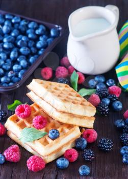 wafels with berry and fresh milk on a table