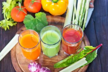 vegetable juice in the glass and on a table
