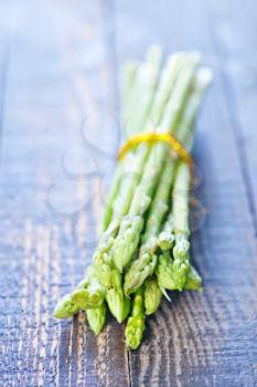 raw asparagus on the wooden table, green asparagus