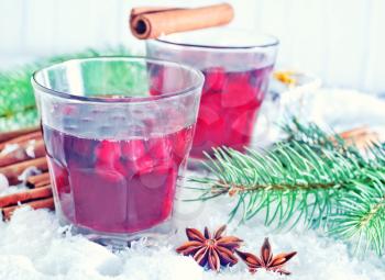 mulled wine in glass and on the white snow