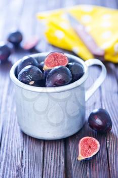 fresh figs in metal cup and on a table