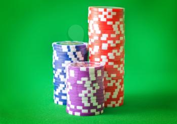 Group from chips for poker on the green background