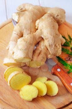 Fresh ginger and knife on the wooden board