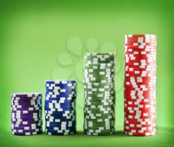 Chips for poker on the green background