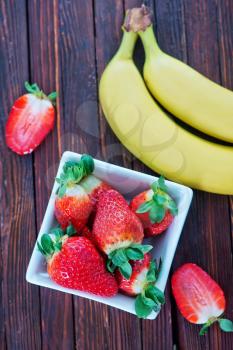 banana and strawberry on the wooden table