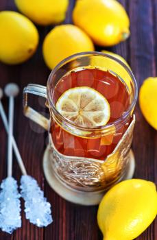 fresh tea with lemon in cup and on a table