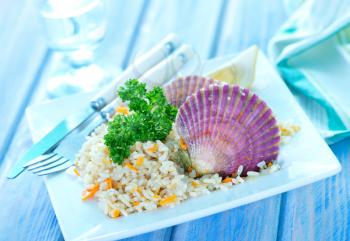 rice with scallop on plate and on a table