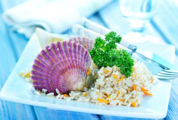 rice with scallop on plate and on a table