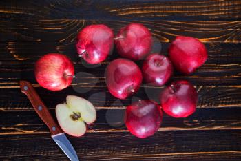 fresh apples and knife on the wooden table
