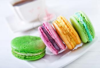 color macaroons on plate and on a table