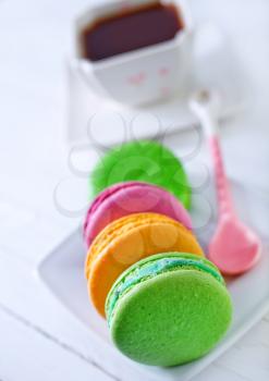 color macaroons on plate and on a table