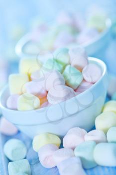 color marshmallow in bowl and on a table