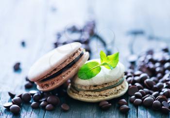chocolate macaroons and mint leaf on a table