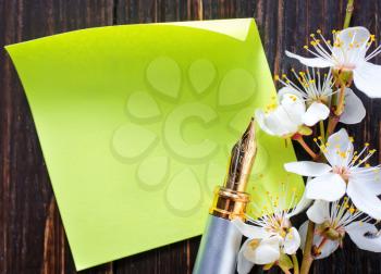 flowers and paper on wooden background