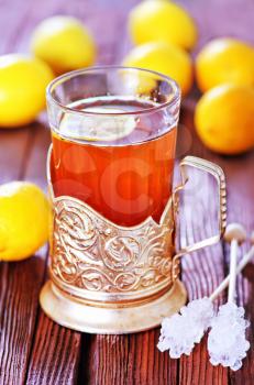 fresh tea with lemon in cup and on a table