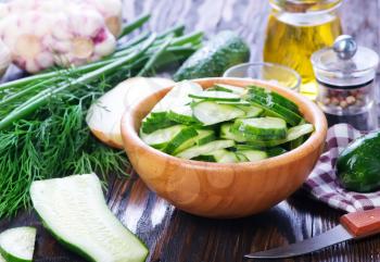 cucumber salad in bowl and on a table