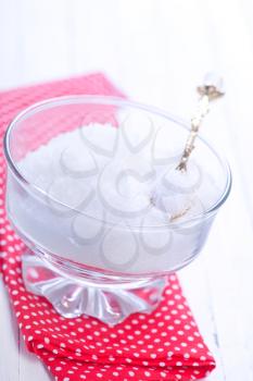 white sugar in glass bank and on a table