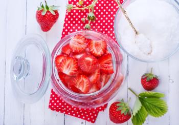 fresh strawberry in glass bank and on a table