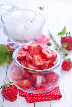 fresh strawberry in glass bank and on a table