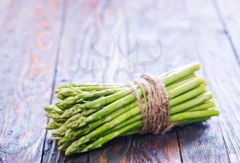 green asparagus on the wooden table, fresh asparagus
