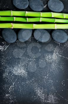 green bamboo and black basalt on a table