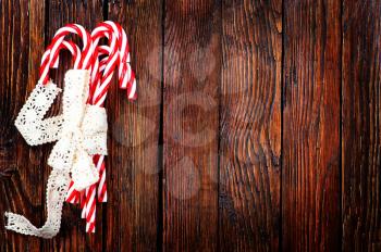 candycanes with white ribbon on the wooden table