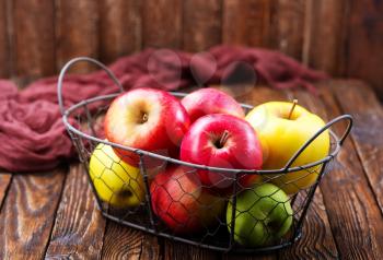 apples on a table, red apples in metal basket