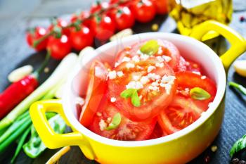 fresh tomato salad on the yellow plate