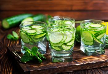 fresh cucumber drink with lemon on the wooden tray