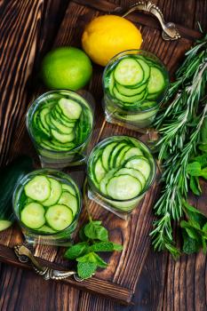 fresh cucumber drink with lemon on the wooden tray