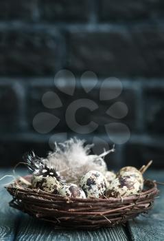 quail eggs in nest and on a table