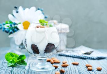 desert with cream and dry almond in glass