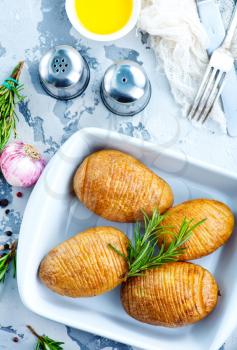 baked potato with rosemary and garlic in bowl