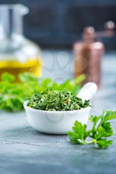 dry parsley in bowl and on a table