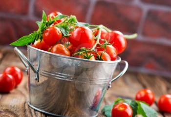 tomato cherry in bowl and on a table