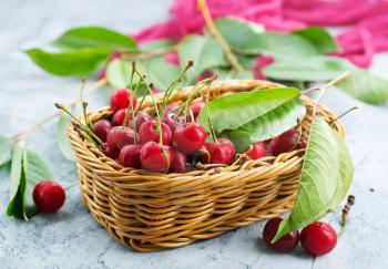 cherry in basket and on a table