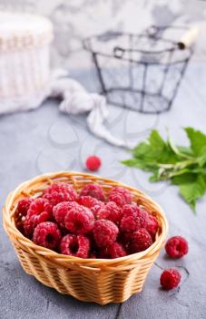 fresh raspberry in basket and on a table