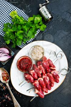 raw chicken hearts with salt and spice