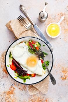 breakfast on plate, fried egg with salad