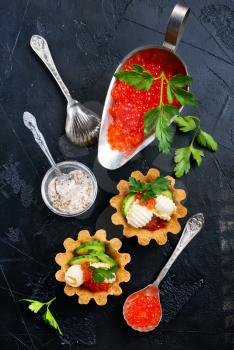 tartalets with butter and salmon caviar, fresh salmon with butter