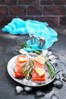 salmon slices with rosemari and lemon, salmon on ice
