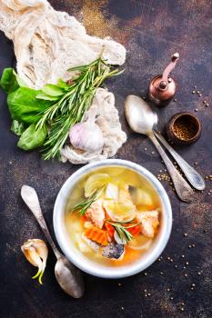 fish soup in bowl, fresh soup with salmon and greens