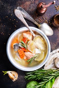 fish soup in bowl, fresh soup with salmon and greens