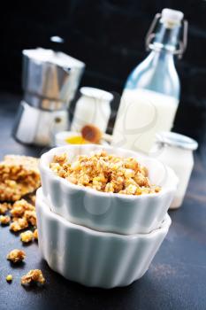 sweet granola with nuts and honey in the bowl