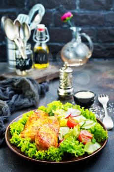 fried chicken breast with green salad and sauce