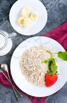 oat flakes with strawberry on white plate