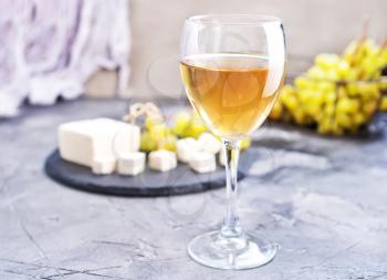 white wine and cheese on a table