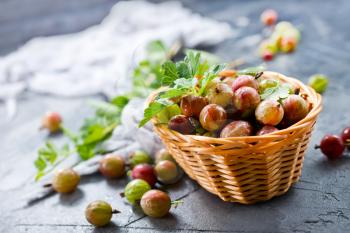 fresh gooseberry in bowl and on a table