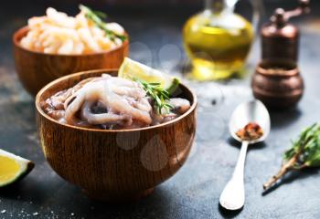 raw octopus in bowls and on a table