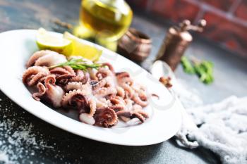 fried octopus on white plate and on a table